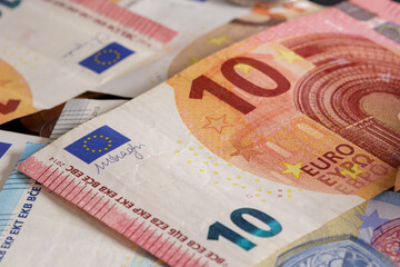 Euro banknotes background with 10 euro banknote in the foreground. Soft focus
