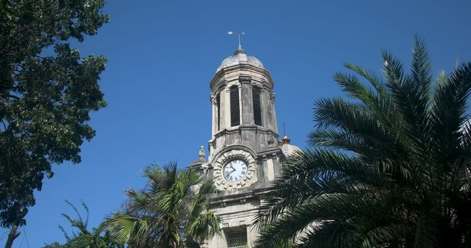 Antigua Caribbean palm tree St Johns Cathedral clock tower. Church of Diocese North Eastern Caribbean and Aruba. Anglican Church of England. Originally built 1683. Seventy foot twin towers.