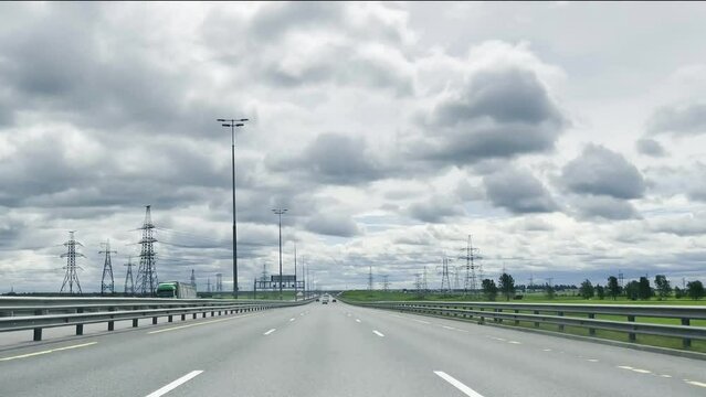 Highway driving in the fast lane with speed signs of 130 km per hour on a cloudy day