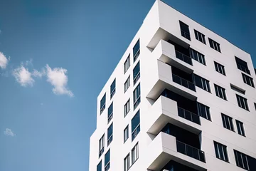 Foto op Plexiglas modern, opulent apartment. A contemporary residential complex in the sunlight. An housing complex in white with a blue sky. A contemporary apartment building's facade. White and black. Generative AI © 2rogan