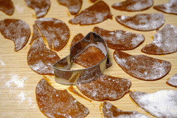 Rolled dough for making cookies cut into molds.
