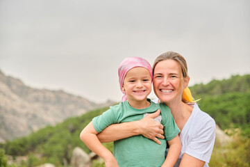 Portrait of a nurse with a child with cancer in nature