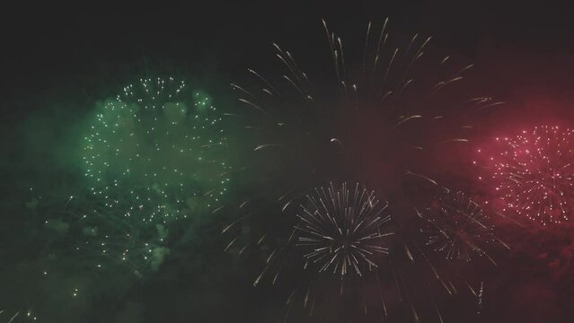 Colorful huge fireworks. Beautiful holiday fireworks close-up view in slow motion. Wonderful real fireworks in the night sky. Fireworks show. 4K slow motion video, ProRes 422, 10 bit ungraded C-LOG.