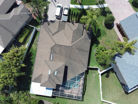 Aerial drone image of a residential house near Tampa Florida with screen enclosure protecting pool