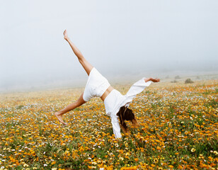 woman in the field doing cartwheel