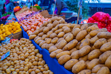 Yellow potatoes and price tag on the bazaar.