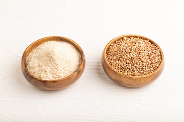 Powdered milk and buckwheat baby food mix, on white wooden, side view