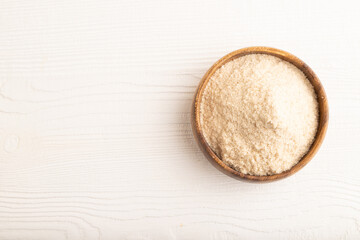 Powdered milk and buckwheat baby food mix, on white wooden, top view, copy space