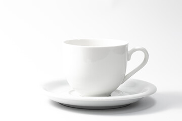 White cup and saucer isolated on white background.