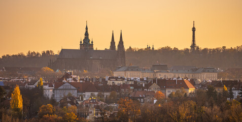 Silhouette of Saint Vitus Cathedral and Petrin Lookout Tower in autumnal haze. Prague Castle, Prague, Czech Republic
