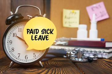On the alarm clock a sticker with the inscription - Paid sick leave
