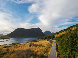 Scenic road on Lofoten islands surrounded by mountains in autumn day, Lofoten Islands, Norway