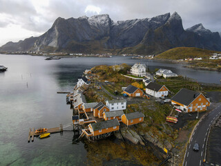 Traditional yellow Rorbuer in fishing village of Sakrisoya in Lofoten Islands in Norway