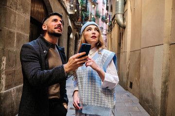 Lost tourist couple locating themselves with the mobile