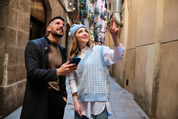 Couple looking and pointing up in the street
