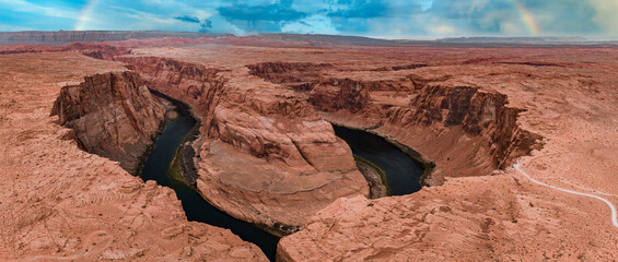 Panorama of Horseshoe Bend, Page Arizona. The Colorado River and a land mass made of orange...