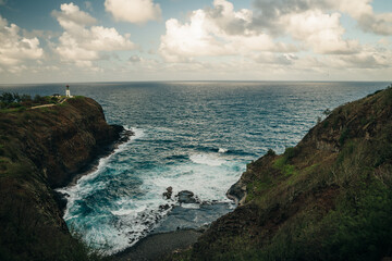 Kilauea Point Lighthouse glowing in the summer sun against a blue sky and ocean, Kauai, Hawaii, USA