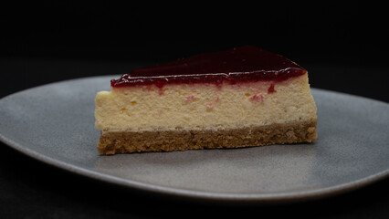 Cheesecake on a white plate. dessert concept. Sliced Cheesecake Plate. Cheesecake with raspberry jelly filling. selective focus Horizontal view.