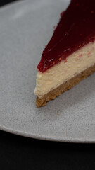 Cheesecake on a white plate. dessert concept. Sliced Cheesecake Plate. Cheesecake with raspberry jelly filling. selective focus Horizontal view.