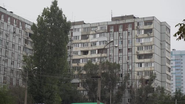 Panoramic view of a large gray Soviet building.