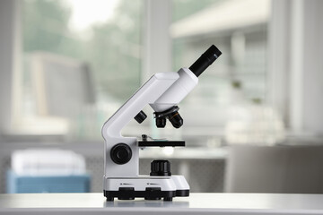 Modern medical microscope on white table in laboratory