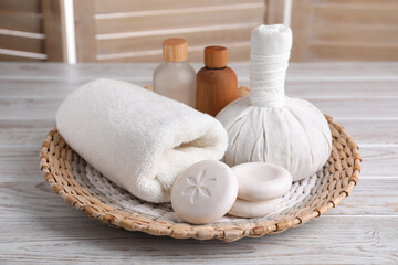 Fototapeta na wymiar Spa composition with skin care products and wicker basket on white wooden table