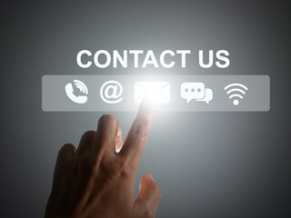 Contact us or Customer support concept. Finger tapping on a virtual screen of contact icons:  phone, address, email, live chat, and internet wifi