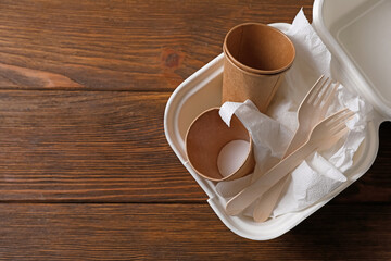 Heap of waste paper on wooden table, top view. Space for text