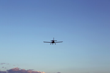 Fototapeta na wymiar Modern ultralight airplane flying in blue sky