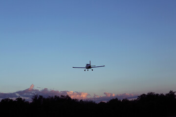 Naklejka na ściany i meble Modern ultralight airplane flying in blue sky