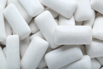 Fototapeta na wymiar Tasty white chewing gums as background, top view