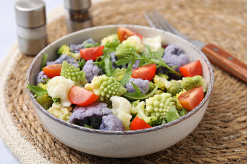 Delicious salad with cauliflower and tomato served on table, closeup