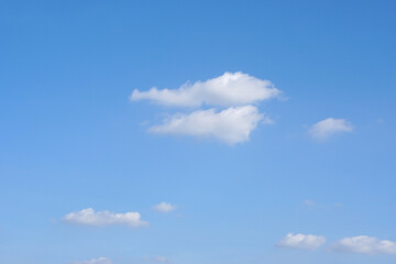 Blue sky with fluffy white clouds constantly changing shape.