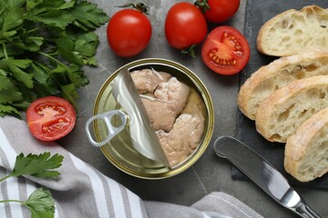 Flat lay composition with tin can of tasty cod liver and different products on grey table