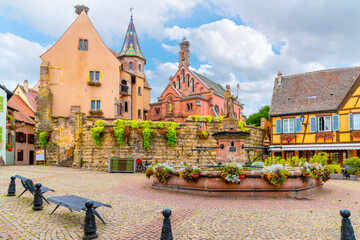 The fountain with statue of Saint Leon in the main square, or Saint-Leon Square of Eguisheim, France in the Alsace region.