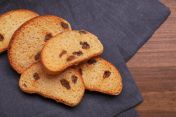 Sweet hard chuck crackers with raisins on wooden table, flat lay