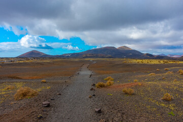 Fototapeta na wymiar Wild volcanic landscape of Los Volcanes Natural Park in Lanzarote, Canary Islands, Spain