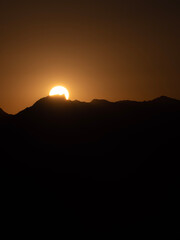 Sun behind the peaks