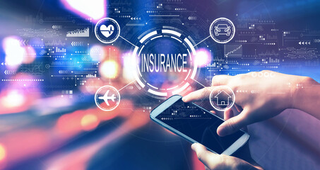 Insurance concept with person using a smartphone in a city at night