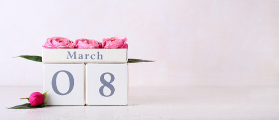 Calendar and flowers for International Women's Day celebration on light background with space for text