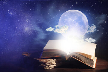 Magic books with moon and night sky on dark background