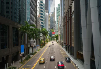 Schilderijen op glas Street and car on traffic moving in downtown business financial district with skyscraper building in morning at Singapore. © ake1150