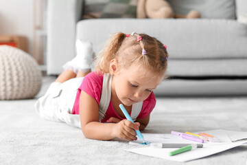 Cute little girl drawing with felt-tip pen on floor at home - obrazy, fototapety, plakaty