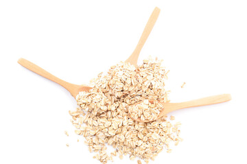Wooden spoons with raw oatmeal isolated on white background