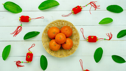 Chinese language mean rich or wealthy and happy.Top view aerial image decoration Chinese new year  lunar new year holiday background concept.Flat lay red orange with blossom on modern  white table.