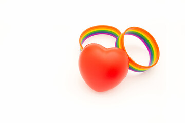 Rainbow patterned wristbands and a red heart shape symbol are on a white background