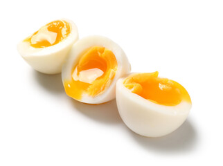 Sliced soft boiled eggs on white background