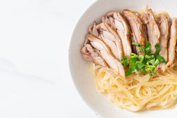 dried noodles with stewed duck in white bowl