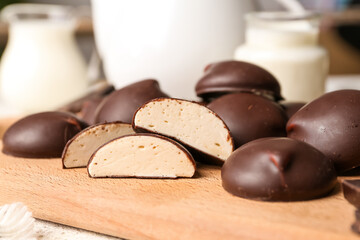 Cutting board with sweet chocolate bird's milk candies, closeup