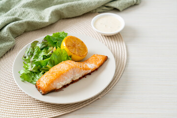fried salmon steak with lemon and vegetable